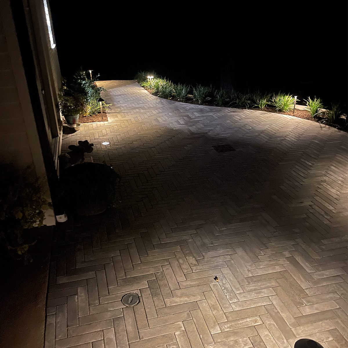 Services-Landscape-Lighting A patio at night lit up by low voltage lighting