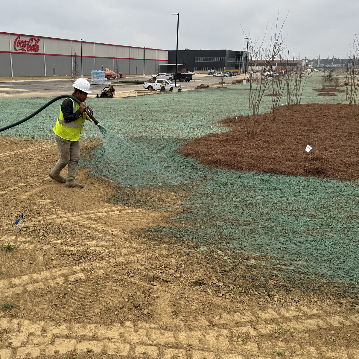 hydroseedpic A worker hydroseeding a dirt lot